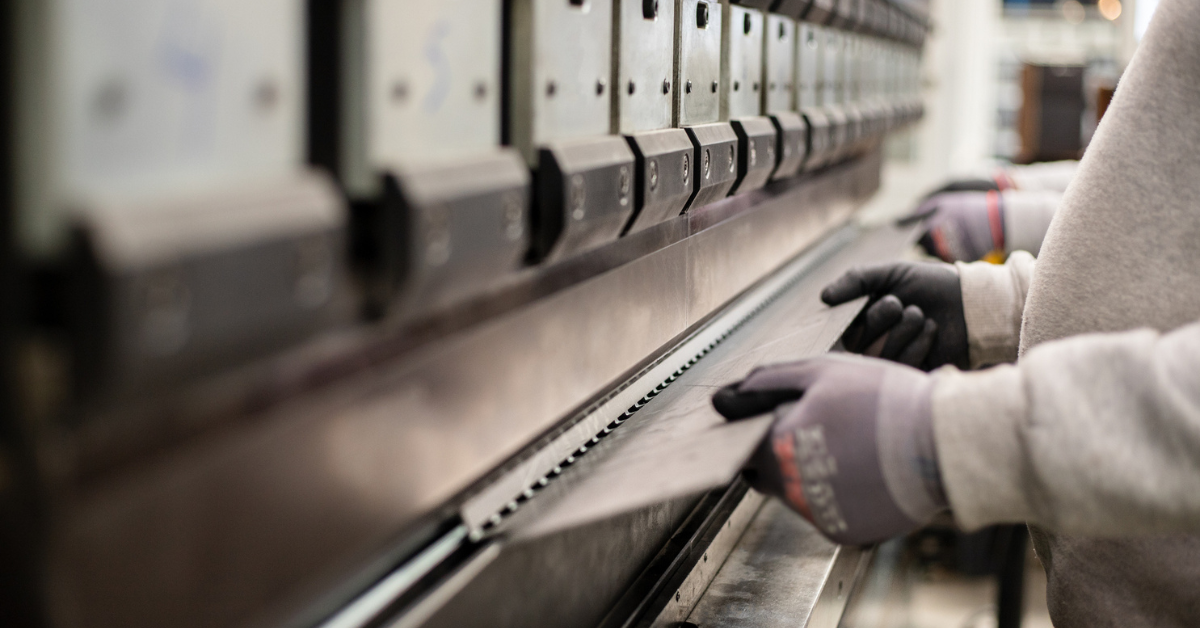 Close up of a piece of metal being formed by a press brake